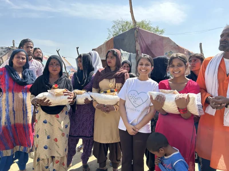 An intern with families at a ration-kit distribution drive